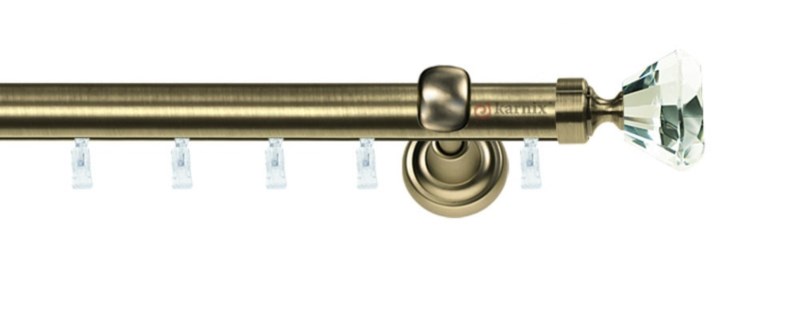 Jednořadá garnýž Aspen Clarex Crystal v mosazi, průměr tyče 25 mm. Speciální konzoly umožňují plynulý posuv závěsů. Montáž na zeď.